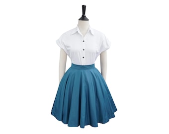 May include: A white button-down shirt with short sleeves and a teal blue circle skirt.