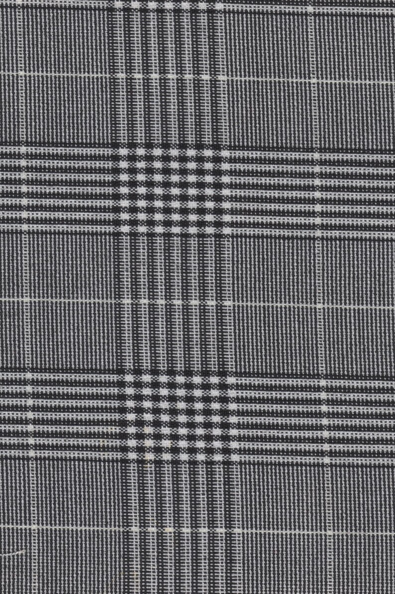 May include: Black and white plaid fabric with a fine weave. The fabric has a subtle sheen and a slightly textured surface.