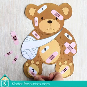 Sick Teddy Counting Activity printable game for preschool and kindergarten math centers. Children match number bandages 1–10 to the teddy bear graphic to practice counting, number recognition, and one-to-one correspondence. A fun, hands-on dramatic play activity that builds fine motor skills and makes learning numbers engaging for early learners.