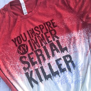 May include: Red and white bleached t-shirt with the text "You inspire my inner serial killer" in black.