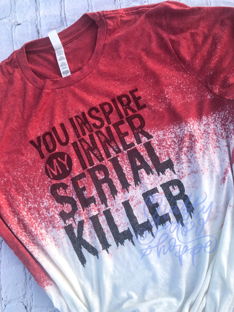 May include: Red and white bleached t-shirt with the text "You inspire my inner serial killer" in black.