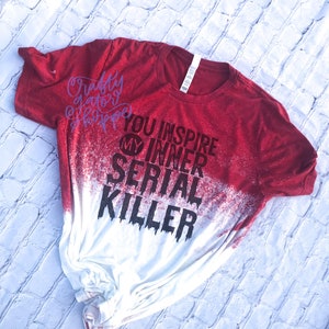 May include: Red and white bleached t-shirt with the text "You inspire my inner serial killer" in black.
