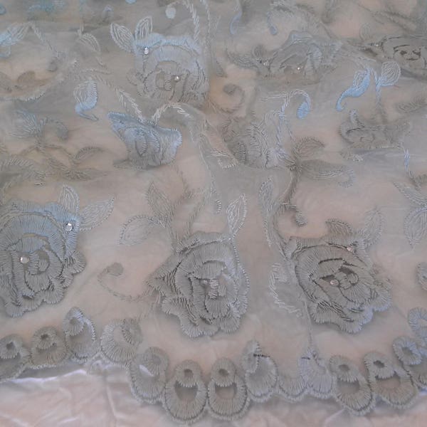 Haute couture organza, scalloped pale green organza, embroidered with flowers and Swarovski crystals.