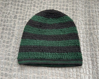 Green and black kufi-style crocheted hat