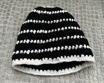White and black kufi-style crocheted hat