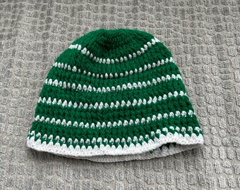 Green and white kufi-style crocheted hat