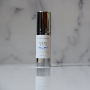 May include: A silver bottle of Northern Elements Polar Lights Retinol + Peptide Night Serum. The bottle is labeled with the product name and description. It contains 1 fl. oz. (30 ml) of serum.
