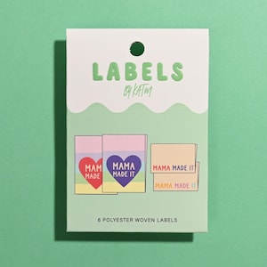 May include: A white and light green rectangular product card labeled LABELS BY KATM containing 6 polyester woven labels. The card displays illustrations of labels with rainbow stripes and heart graphics featuring the text MAMA MADE IT.