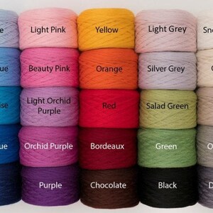 May include: A collection of colorful yarn skeins in various shades, including blue, pink, yellow, and green. Each skein is labeled with its color name, such as "Air Blue," "Light Pink," and "Yellow." The yarn appears to be soft and suitable for knitting or crochet projects.