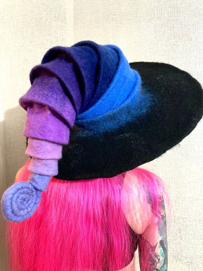 May include: A black felt witch hat with a large brim and a purple, blue, and black gradient spiral on the side.
