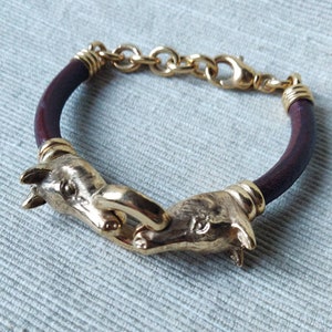 Vintage bracelet, with golden horse heads and leather strap