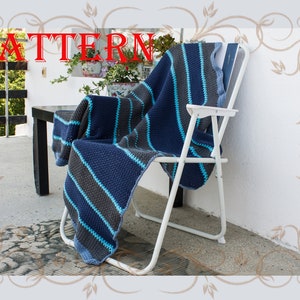 May include: A blue and gray striped crocheted throw blanket draped over a white folding chair on a patio.