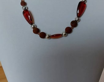 A brown-silver necklace with lava beads and crystals