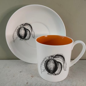 Lovely 3&quot; Susie Cooper Black Fruit Tea cup/Coffee Can and saucer by Wedgwood. Bone China with Peach design and orange interior. Lovely gift.