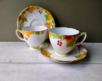 Lovely pair of A. B. Jones Grafton China art deco teacups and saucers with hand painted autumn pattern 5554 in yellow and green Lovely gift.