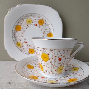 Gorgeous Bell China Trio of Side plate, teacup and saucer. Art deco shape 4371 floral pattern with yellow flowers. Lovely gift.