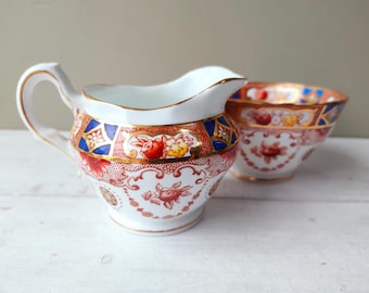 Gorgeous sugar bowl and creamer set by Royal Stuart, Spencer Stevenson, England. Cobalt blue and orange floral Imari pattern. Lovely gift.