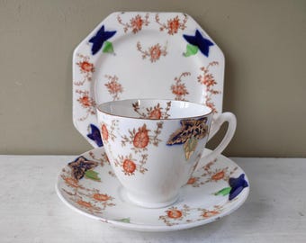 Gorgeous Trio of Side plate, teacup and saucer. "Guaranteed English Bone China" with cobalt blue and orange floral pattern. Lovely gift.