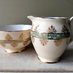 Lovely Fine Bone China footed sugar bowl and creamer/jug by Roslyn China. Classical green cream and gold pattern. Lovely gift.
