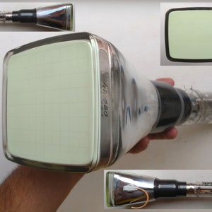 Puede incluir: Un tubo de televisión vintage con una pantalla verde y una carcasa de metal negro y plateado. El tubo está etiquetado como "6363" y tiene un patrón de cuadrícula en la pantalla.