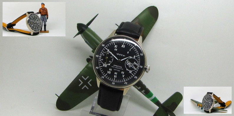May include: A black-faced Doxa Special watch with a black leather band, displayed on a model airplane. The watch has white numerals and hands. A small figurine of a pilot stands nearby. The airplane is green and brown.