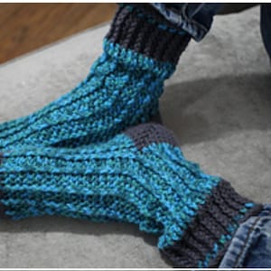 May include: A pair of blue and gray knitted socks with a textured pattern. The socks are made with a soft yarn and are perfect for keeping your feet warm in the winter.