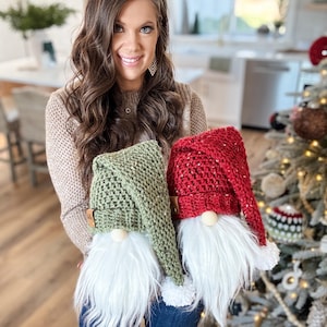 May include: Two handmade gnomes with white fur beards and crocheted hats. One gnome has a green hat and the other has a red hat.