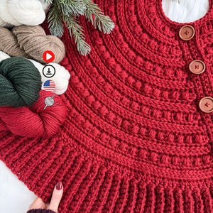May include: A handmade, red crocheted Christmas tree skirt with a textured design and three wooden buttons. The skirt is circular with a center opening and a ribbed edge. Yarn skeins in various colors are visible.