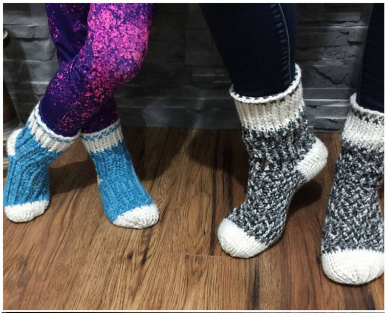 May include: Two pairs of knitted socks, one pair is blue and white, the other pair is gray and white.