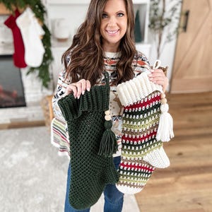 May include: Two handmade Christmas stockings. One is dark green with a tassel and wooden bead detail. The other is striped with white, red, green, and brown. Both are crocheted and have a loop for hanging.