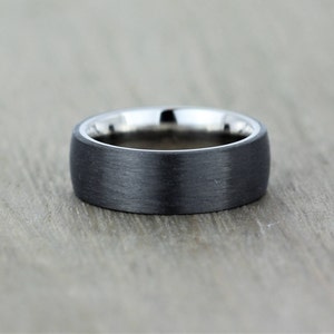 Slight court wedding ring in a satin black finish with a polished titanium inside sleeve. black and silver band in euro dome shape, 7mm wide comfort fit. sizes Z+