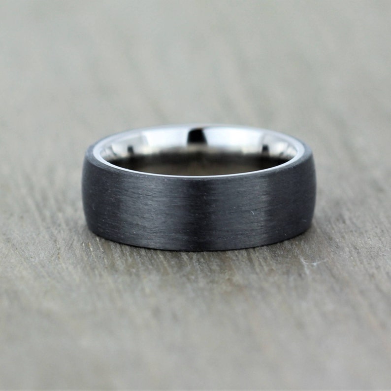 Slight court wedding ring in a satin black finish with a polished titanium inside sleeve. black and silver band in euro dome shape, 7mm wide comfort fit. sizes Z+