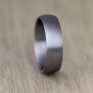 court profile Tantalum wedding ring band. Mans wedding ring in gunmetal grey. 6mm wide with a heavy brushed finish and engravable inside men's wedding band in this alternative metal. made in the UK