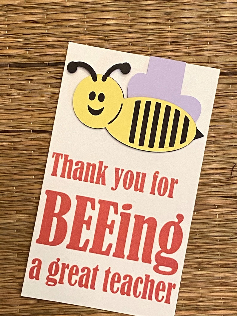 May include: A white card with a yellow and black bee illustration and the text "Thank you for BEEing a great teacher".