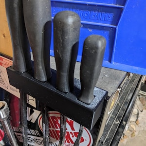 New Design! Universal Pry bar holder 3D printed for 4 pry bars. Fits on tool box lip. Now with an option for larger bars like Tekton and MAC