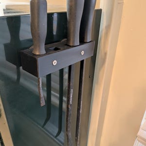 Universal Pry bar holder 3D printed for 4 pry bars. Fits on tool box lip.