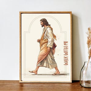 May include: Framed art print featuring a watercolor illustration of a figure in flowing robes walking. The figure is depicted in profile, with long hair and a beard. The text "WALK WITH ME" is printed vertically in a rust-colored font.