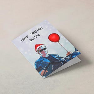 Funny Terminator Christmas card featuring Arnold Schwarzenegger with festive design and humorous quote, perfect for movie fans during the holidays.
