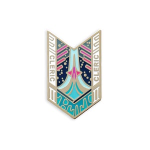 May include: A gold-colored enamel pin in a shield shape with a geometric design. The pin features teal, pink, and navy blue accents. The word "CLERIC" is written vertically on both sides of the pin.