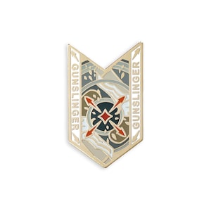 May include: Gold-colored enamel pin with a compass design and the word "GUNSLINGER" on each side. The compass features a red diamond in the center and four red arrows pointing outward.
