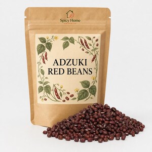 May include: A brown paper stand-up pouch labeled Spicy Home Organics Adzuki Red Beans with a botanical illustration of bean plants. A large pile of small, dark red, oval-shaped adzuki beans is positioned in front of the pouch on a white surface.
