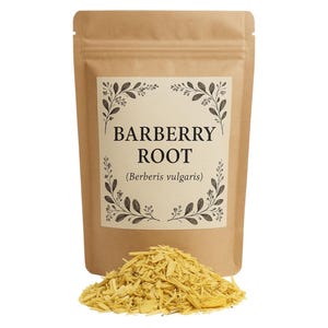 May include: A brown paper bag with a label that reads "BARBERRY ROOT (Berberis vulgaris)". The bag contains yellow, dried, shredded barberry root.