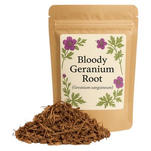 May include: A brown paper bag with a label that reads "Bloody Geranium Root (Geranium sanguineum)". The label features a drawing of a purple flower with green leaves. A pile of dried brown roots is in front of the bag.