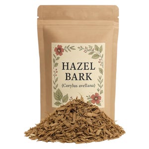 May include: A brown paper bag with a label that reads "Hazel Bark (Corylus avellana)". The bag is filled with loose, brown, shredded bark.