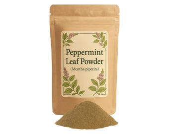 May include: A brown paper bag with a label that reads "Peppermint Leaf Powder (Mentha piperita)". The label features a drawing of a peppermint plant. A pile of dried peppermint leaf powder is in front of the bag.