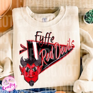 May include: A cream-colored sweatshirt with a red and black pennant design that says "Fyffe Red Devils". A cartoon red devil with horns and a goatee is in the lower left corner of the design.