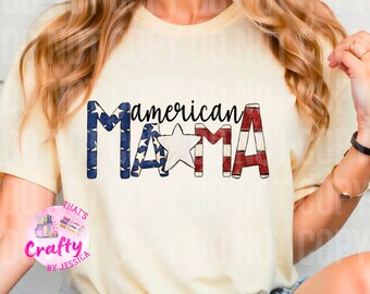 May include: A white t-shirt with the text "american MAMA" in red, white, and blue. The letters are decorated with a pattern resembling the American flag. The text "THAT'S Crafty BY JESSICA" is in a pink circle on the left side of the shirt.