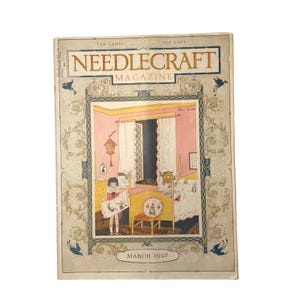 May include: Vintage "Needlecraft Magazine" cover from March 1927. The cover features an illustration of a child holding a framed needlework piece in a pink room with an open window. The magazine title is in a gold font.