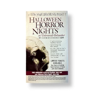 May include: A promotional poster for Halloween Horror Nights at Universal Orlando. The poster features a distressed face with wide eyes and the event's title in large, bold letters. The poster includes event dates and attractions.