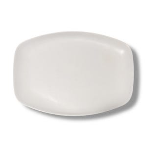 May include: A white, rectangular ceramic plate with rounded corners. The plate has a smooth, glossy surface and is set against a white background. The plate's shape is slightly asymmetrical, with one side appearing more curved than the other.